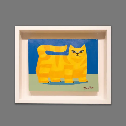 Yellow cat artwork in a pale wood frame with a deep raised mount