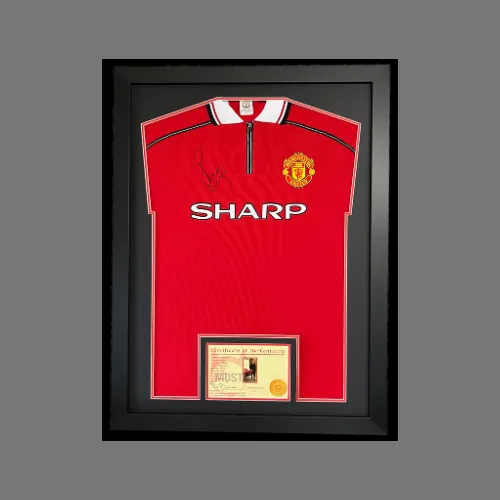 Signed Manchester United shirt in a black box frame with an engraved plaque