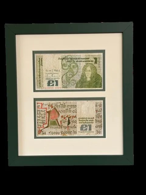 Two Irish pound notes in a green frame with a cream mount and a green slip